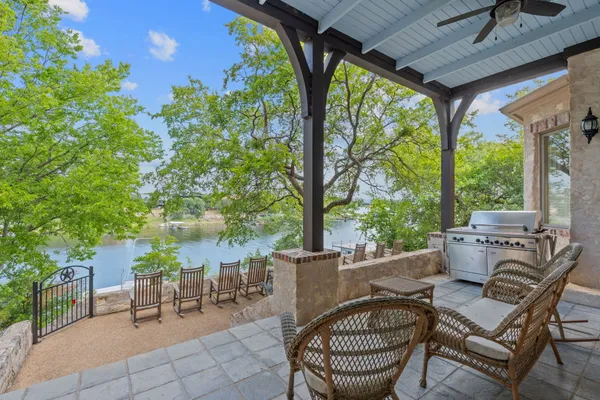 a view of a patio with table and chairs and potted plants
