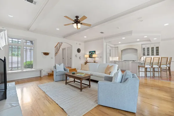 a living room with furniture and a wooden floor