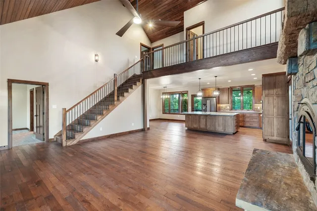 a view of a livingroom with wooden floor and furniture