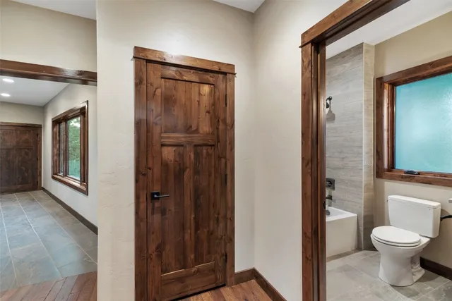 a bathroom with a toilet a sink and mirror