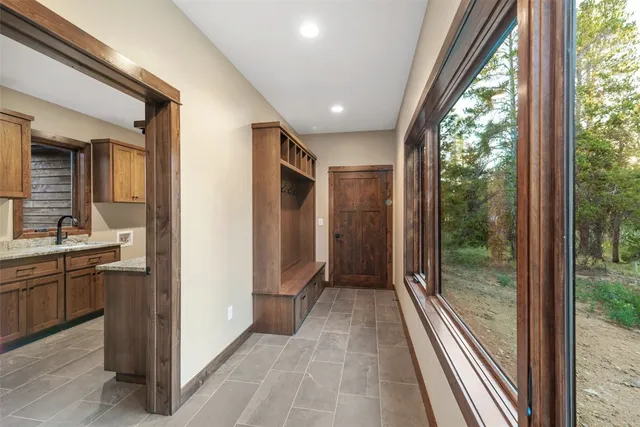 a view of hallway with a large mirror and shower