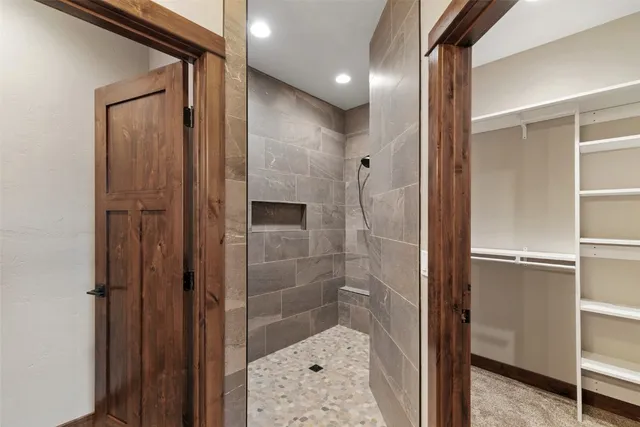 a bathroom with a shower and a glass door