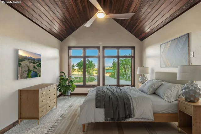 a spacious bedroom with a large bed and a large window