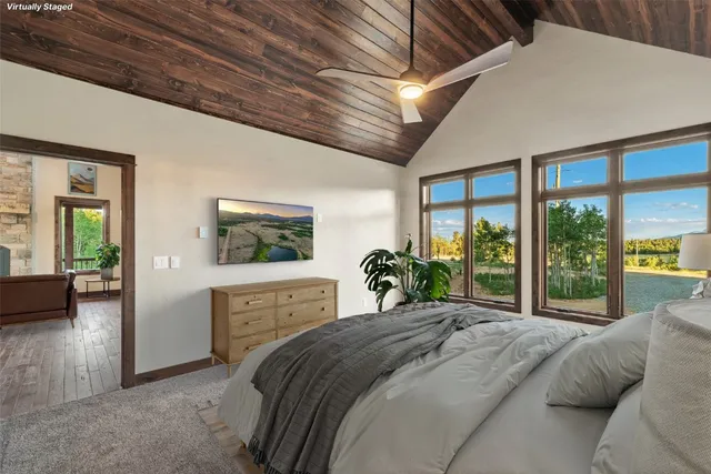 a bedroom with a large bed and a window