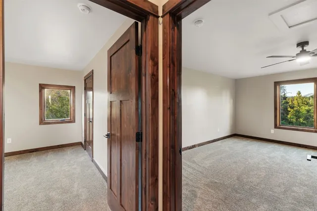 an empty room with windows and closet