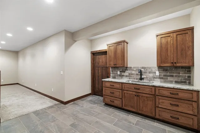 a bathroom with a granite countertop sink a toilet and shower