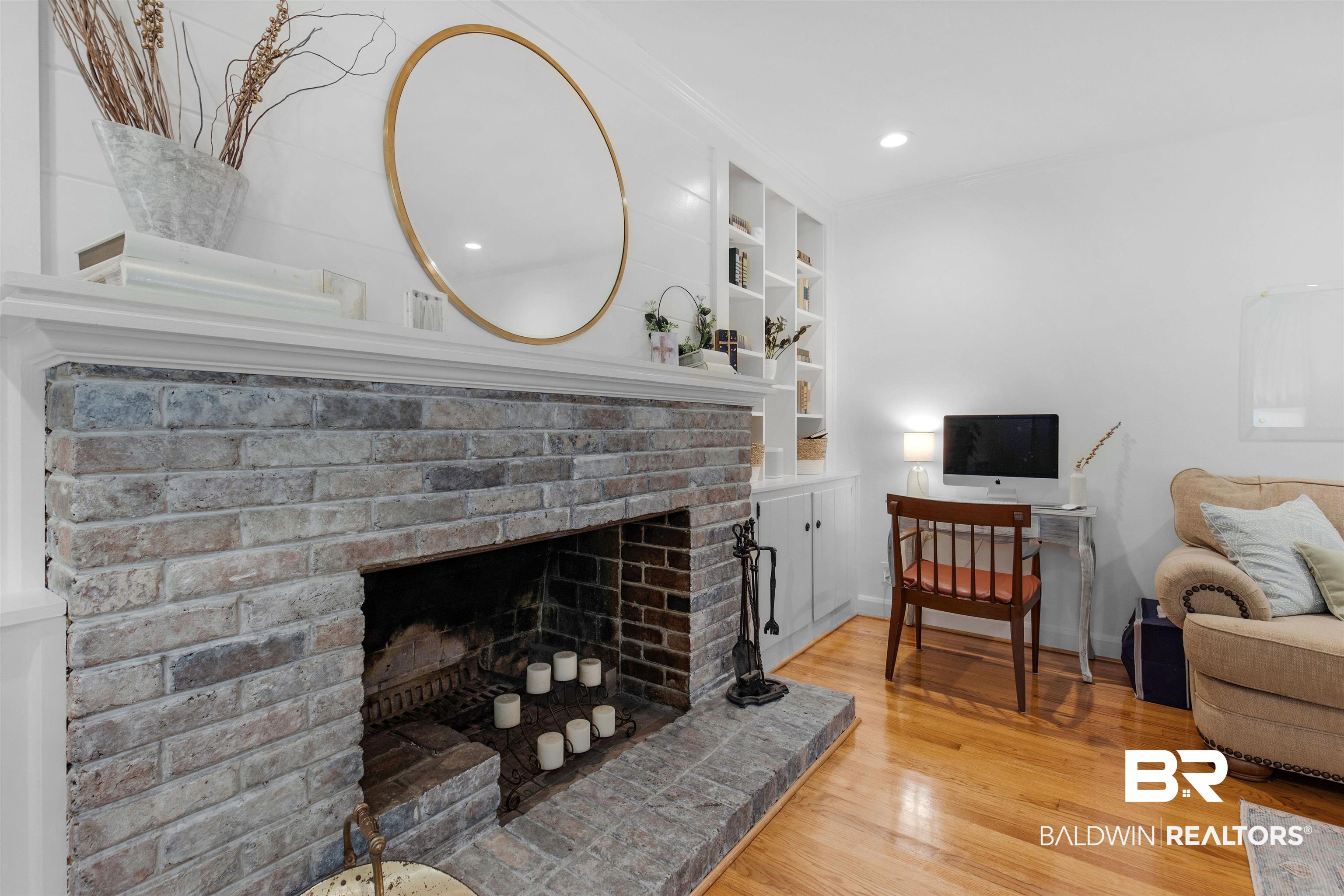 4306 Michael Boulevard Mobile, AL 36609 - Photo 10 of 35 Living room featuring hardwood / wood-style floors, built in features, and a brick fireplace