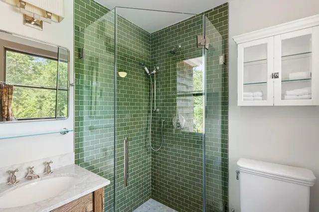 a bathroom with a sink toilet and shower