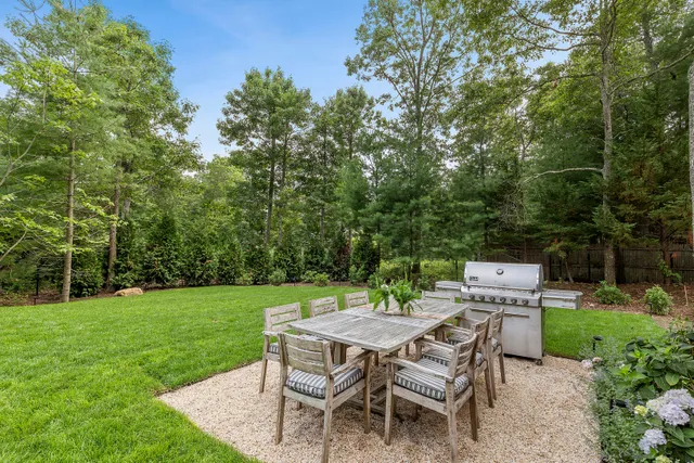 a table and chairs with the view of trees