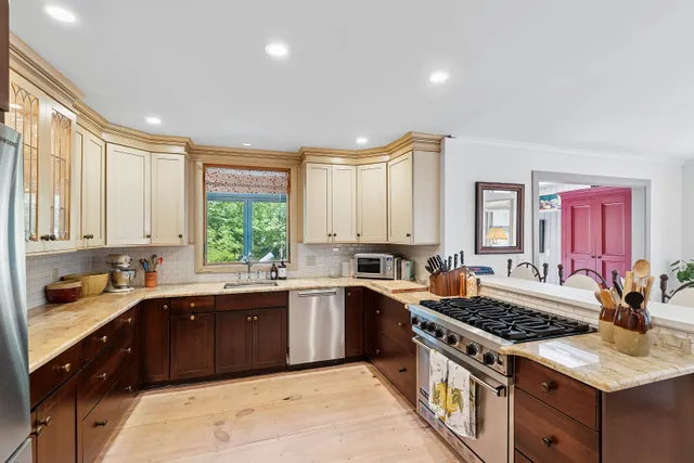 a kitchen with a sink stove top oven and cabinets