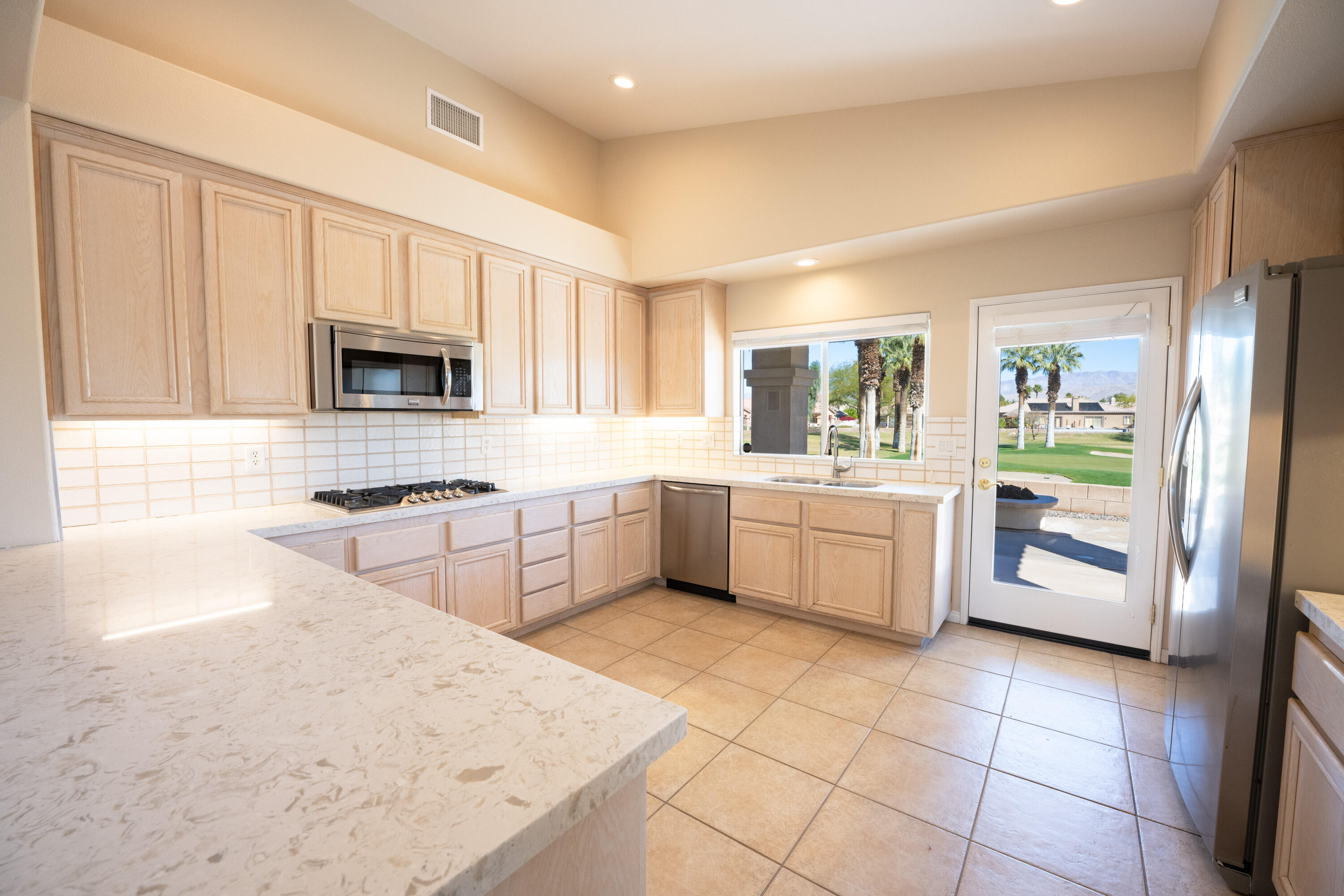 80162 Pebble Beach Drive Indio, CA 92201 - Photo 12 of 48 a kitchen with a sink a stove cabinets and counter space