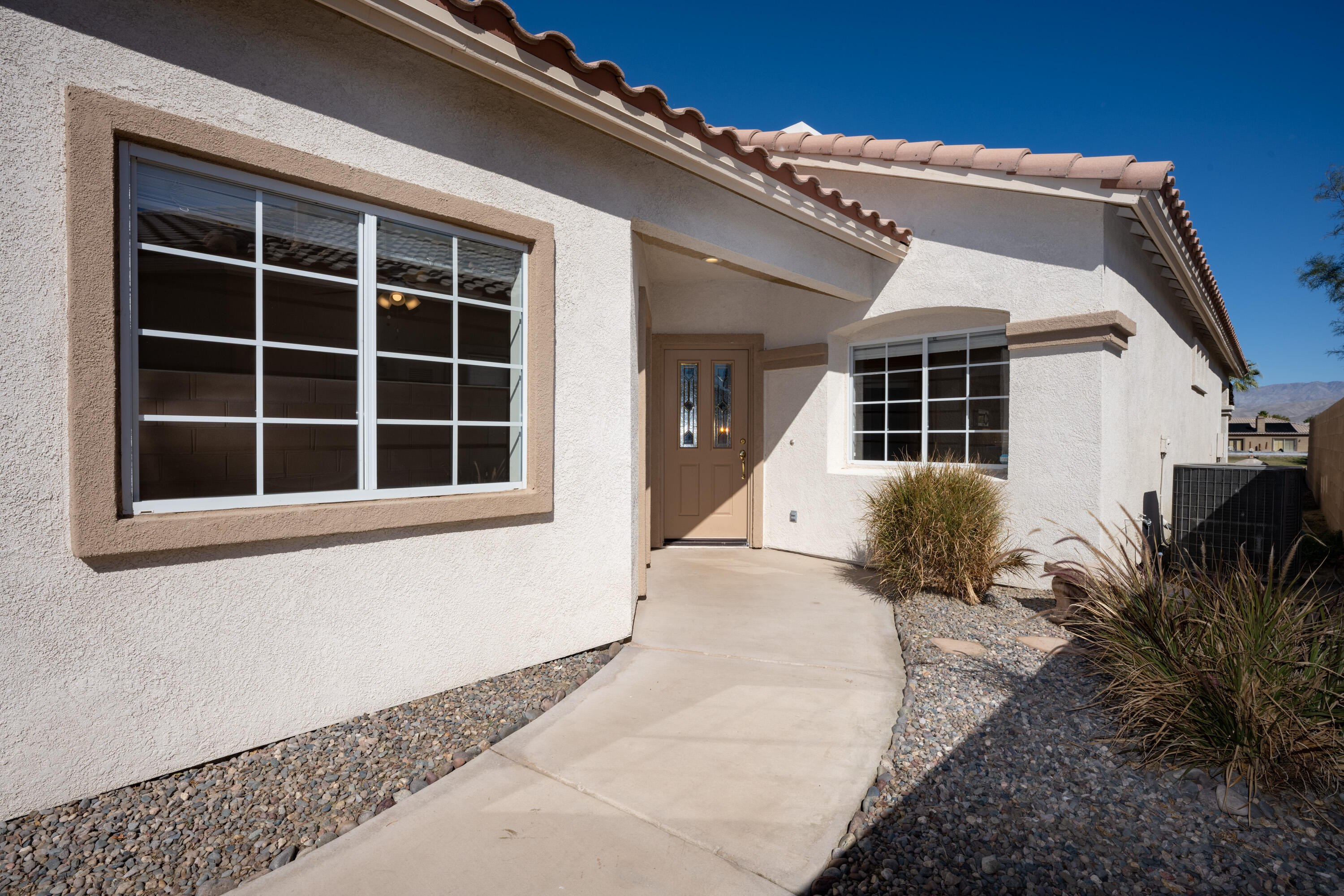 80162 Pebble Beach Drive Indio, CA 92201 - Photo 6 of 48 a front view of a house with a yard and garage