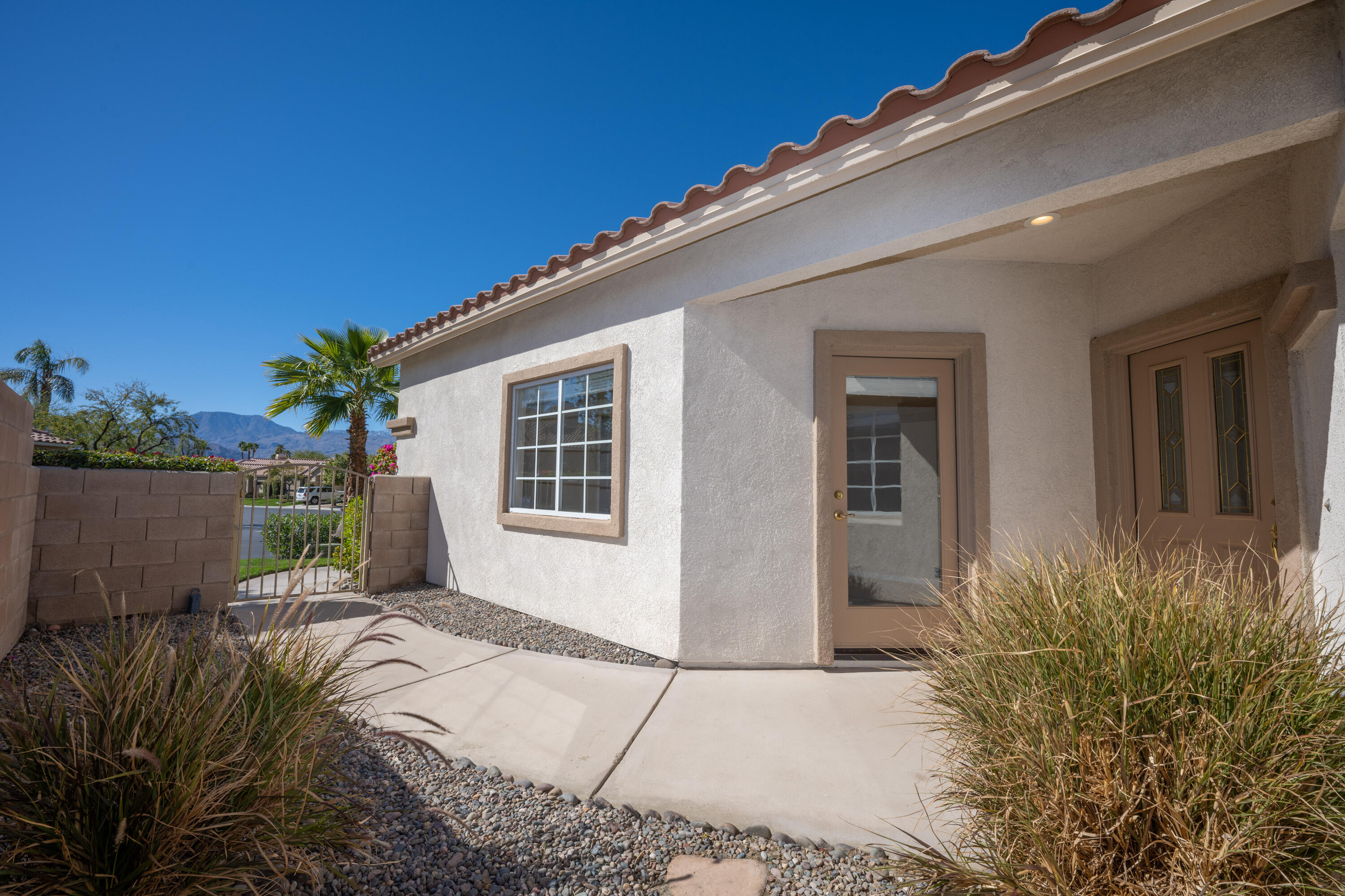 80162 Pebble Beach Drive Indio, CA 92201 - Photo 7 of 48 a front view of a house with a yard