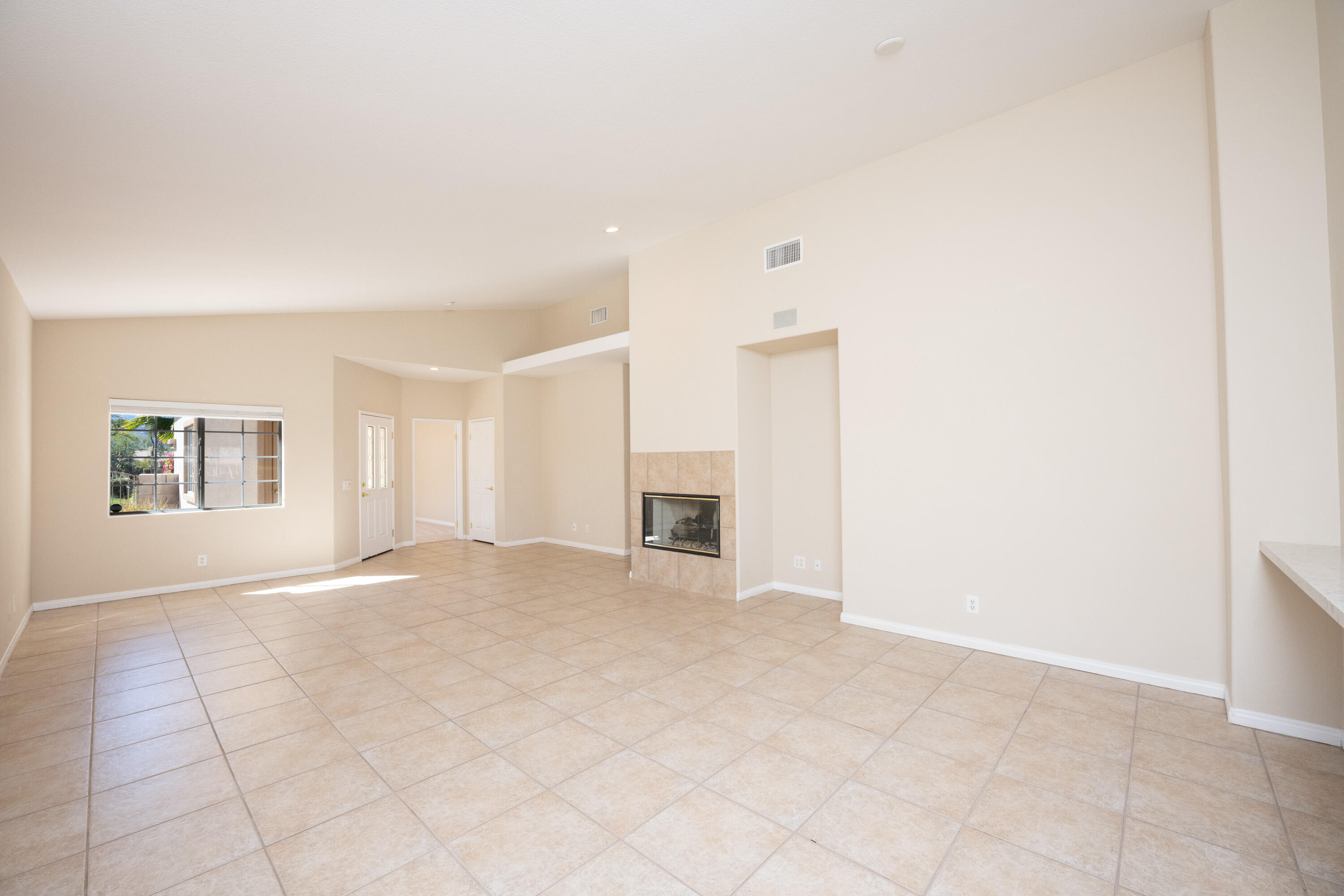 80162 Pebble Beach Drive Indio, CA 92201 - Photo 9 of 48 an empty room with windows and fireplace