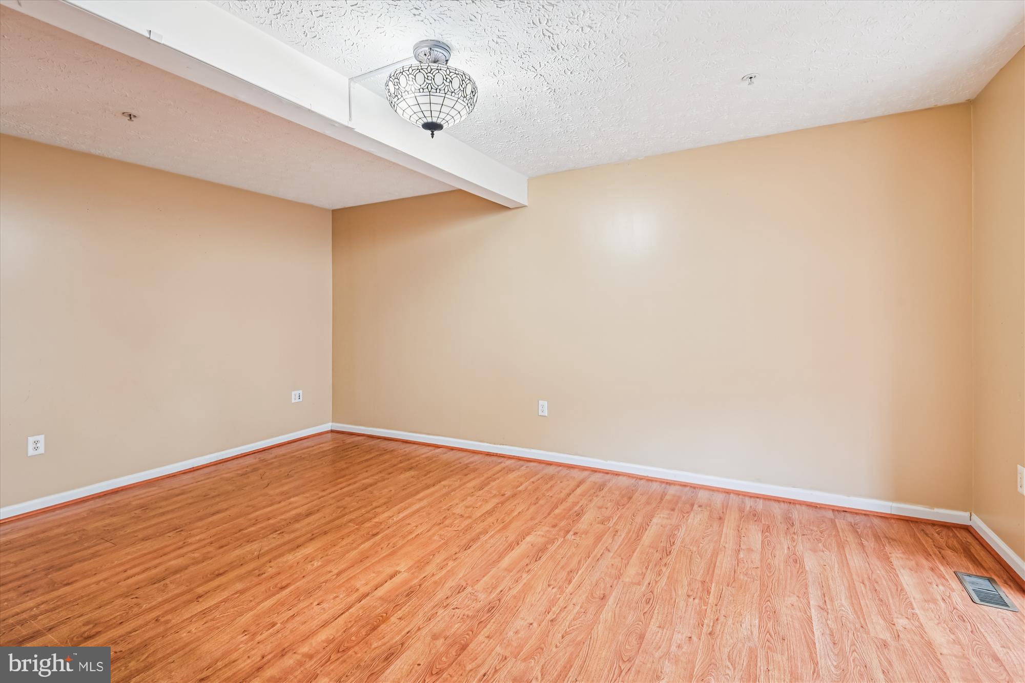 8018 Brookmead Court Severn, MD 21144 - Photo 14 of 35 a view of an empty room with wooden floor