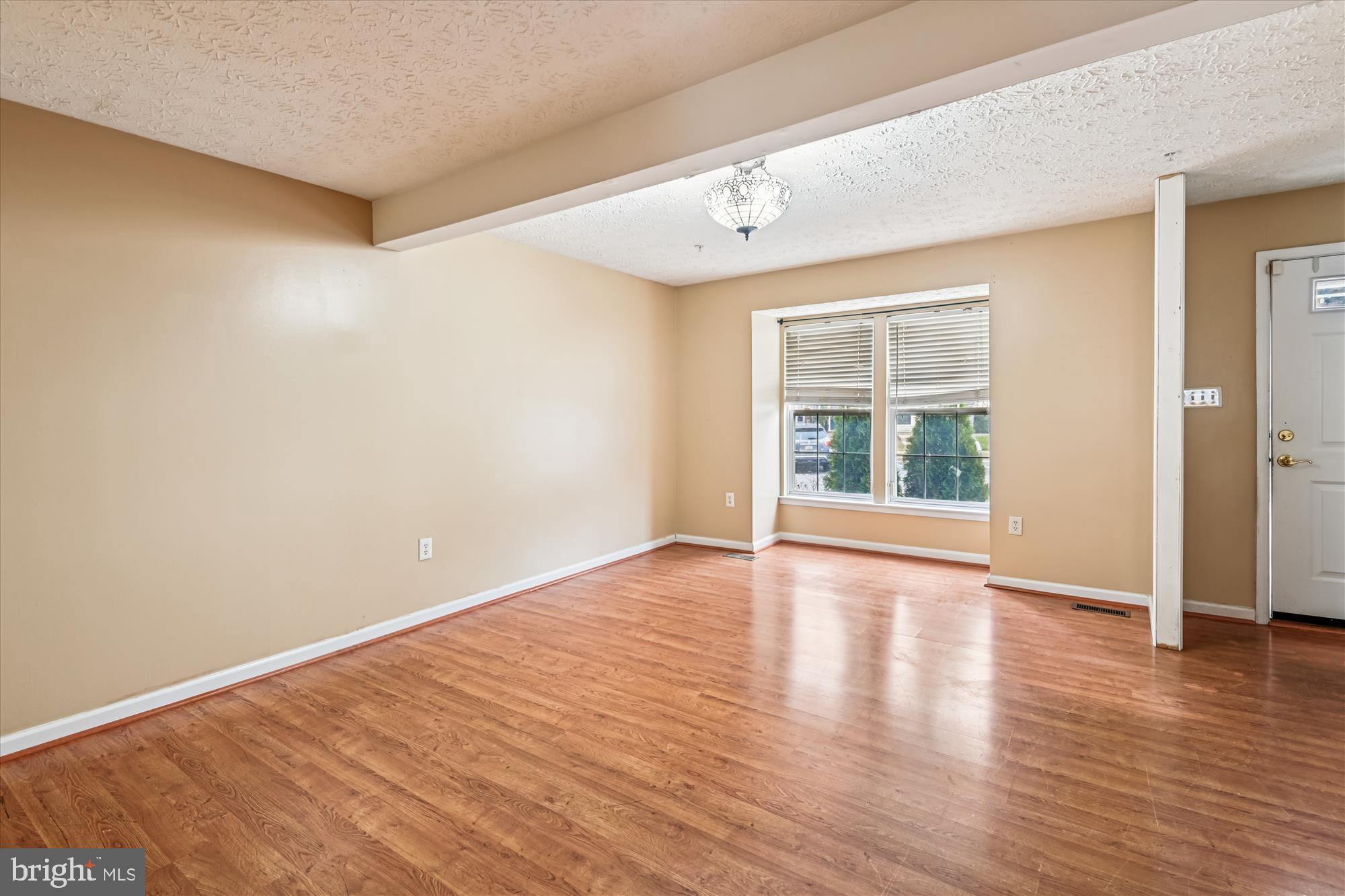 8018 Brookmead Court Severn, MD 21144 - Photo 16 of 35 a view of an empty room with wooden floor and windows