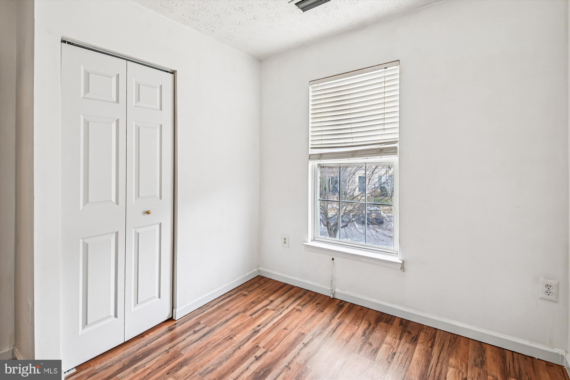 8018 Brookmead Court Severn, MD 21144 - Photo 21 of 35 an empty room with wooden floor and windows