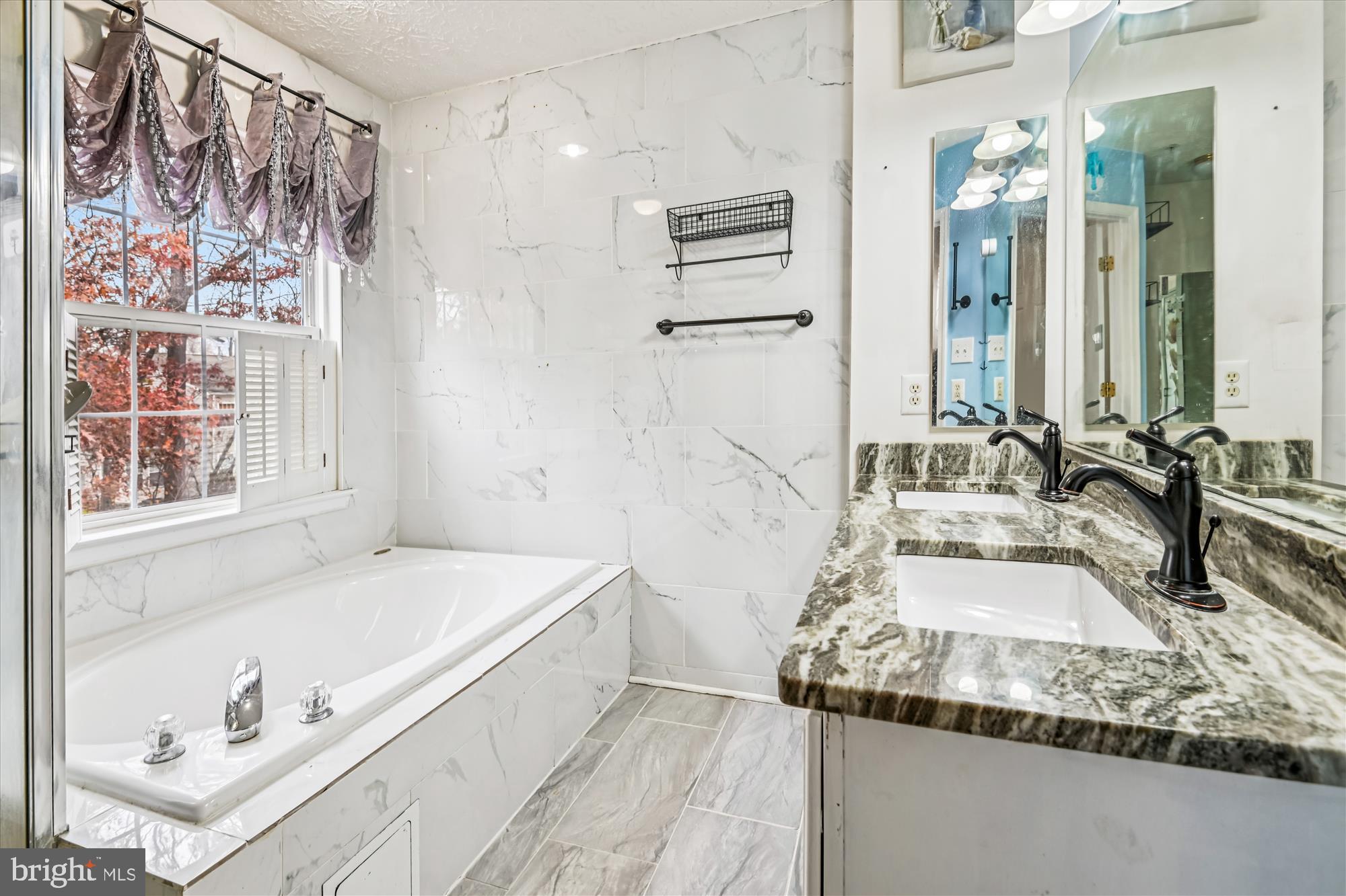8018 Brookmead Court Severn, MD 21144 - Photo 22 of 35 a bathroom with a tub sink and mirror