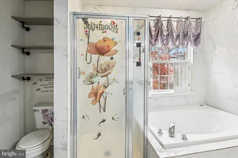 a bathroom with a bathtub and shower