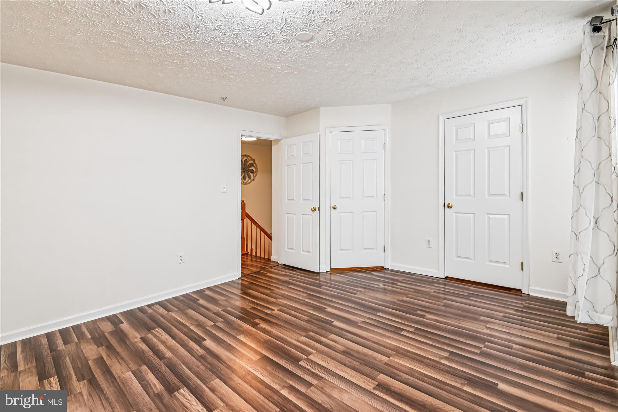 8018 Brookmead Court Severn, MD 21144 - Photo 26 of 35 a view of an empty room with wooden floor
