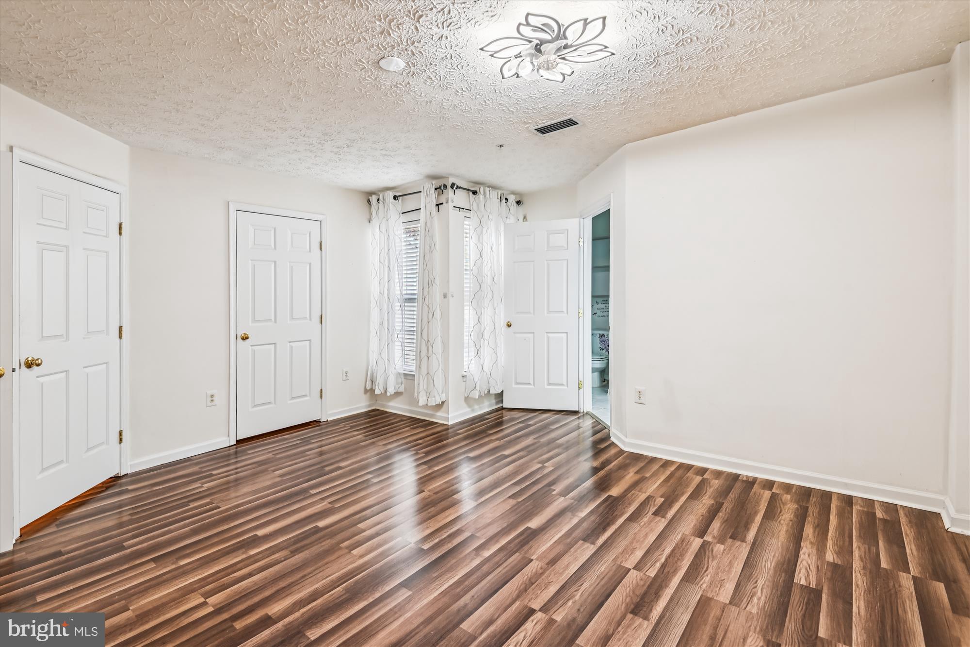 8018 Brookmead Court Severn, MD 21144 - Photo 27 of 35 a view of an empty room with wooden floor