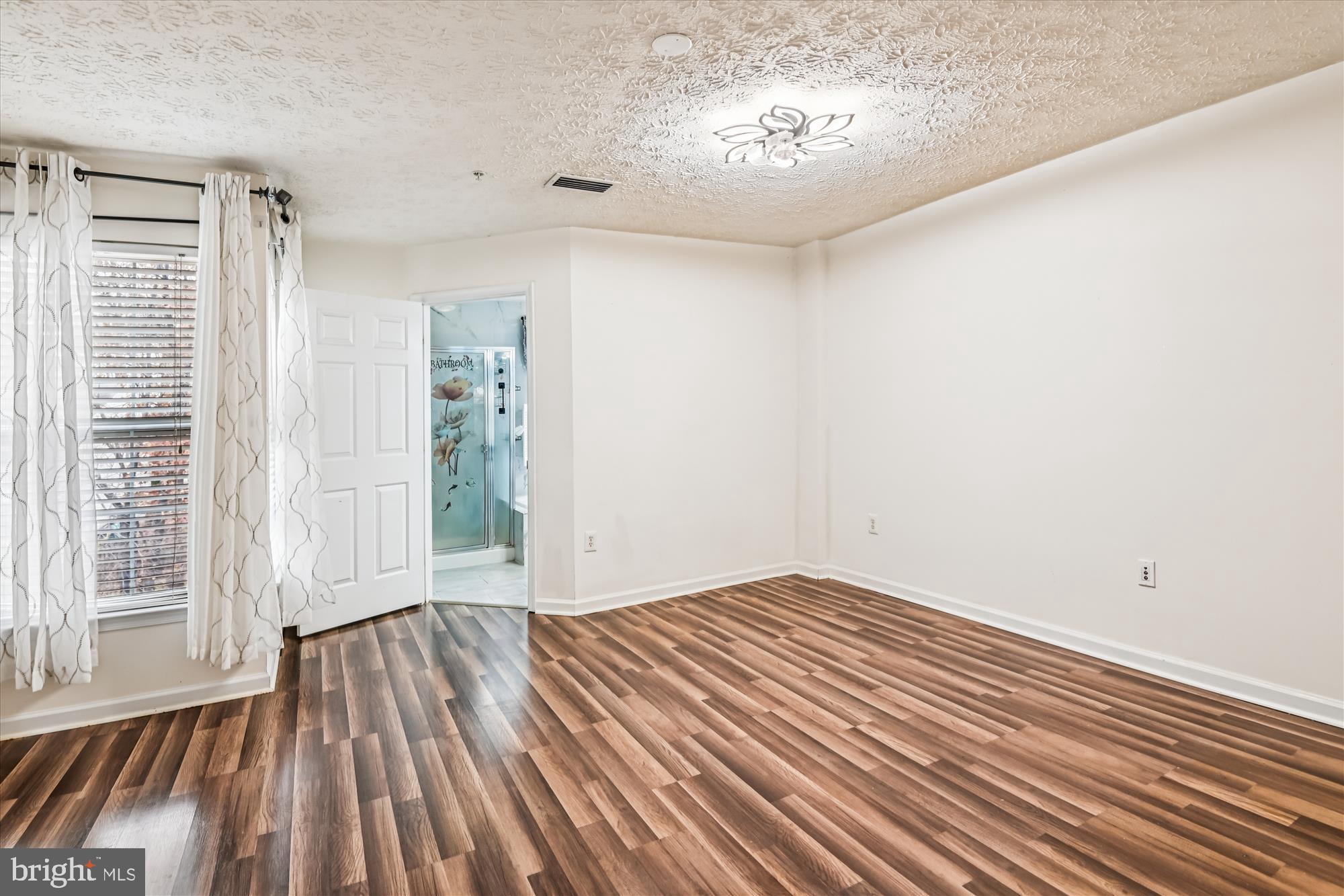 8018 Brookmead Court Severn, MD 21144 - Photo 28 of 35 a view of a room with wooden floor and a window