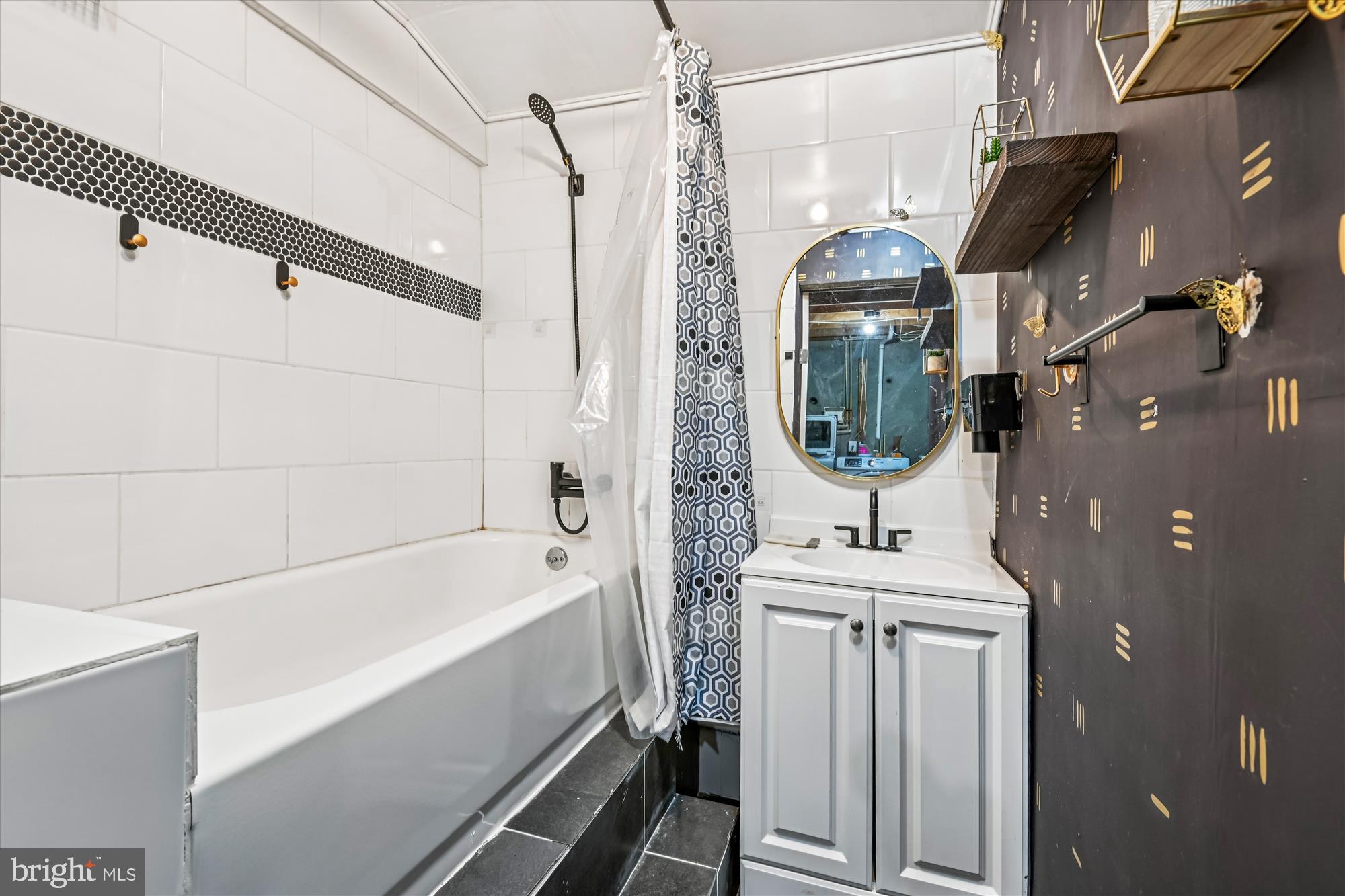 8018 Brookmead Court Severn, MD 21144 - Photo 29 of 35 a bathroom with a sink a mirror and bathtub