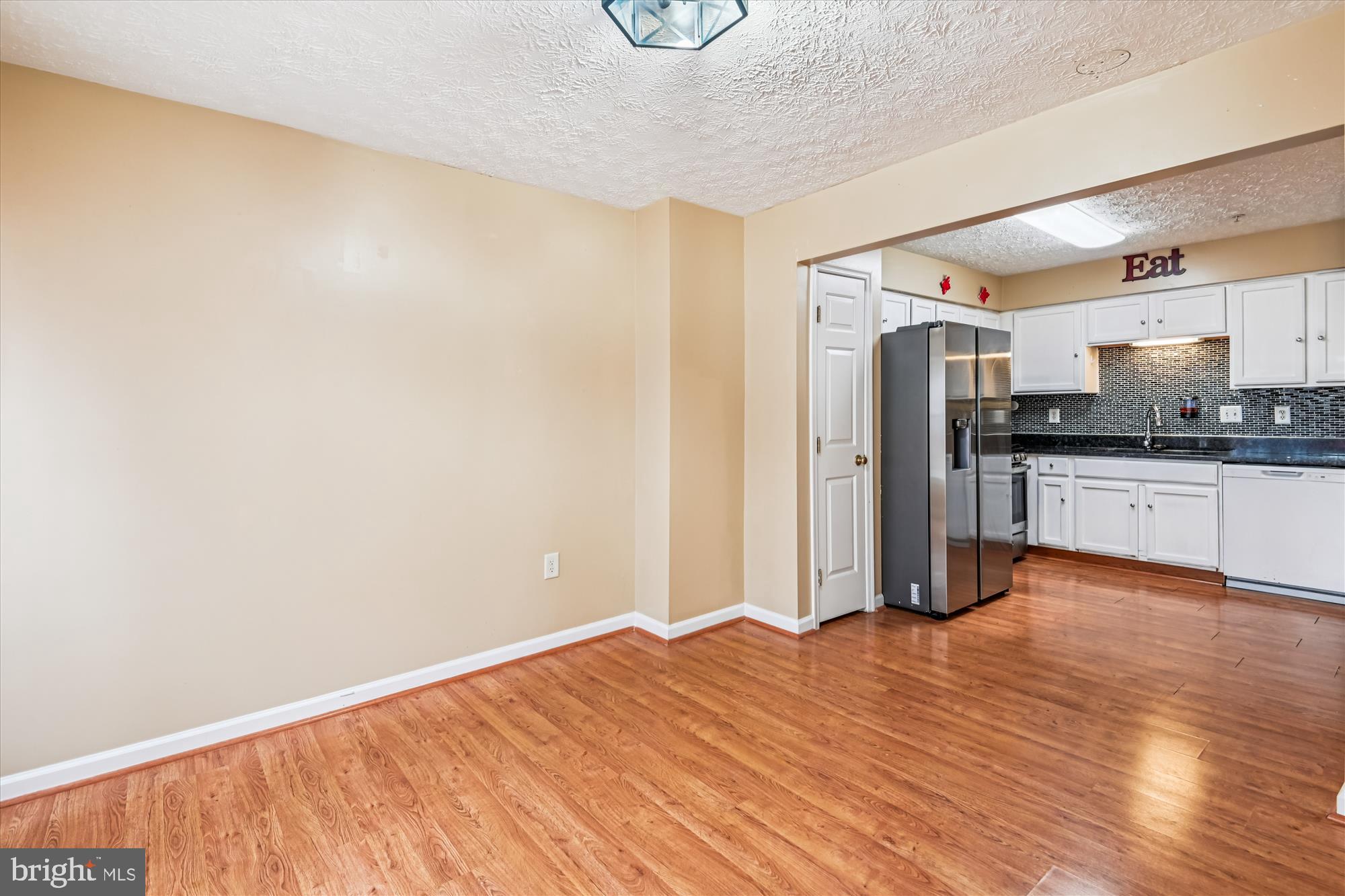 8018 Brookmead Court Severn, MD 21144 - Photo 9 of 35 a view of a kitchen with wooden floor and a sink