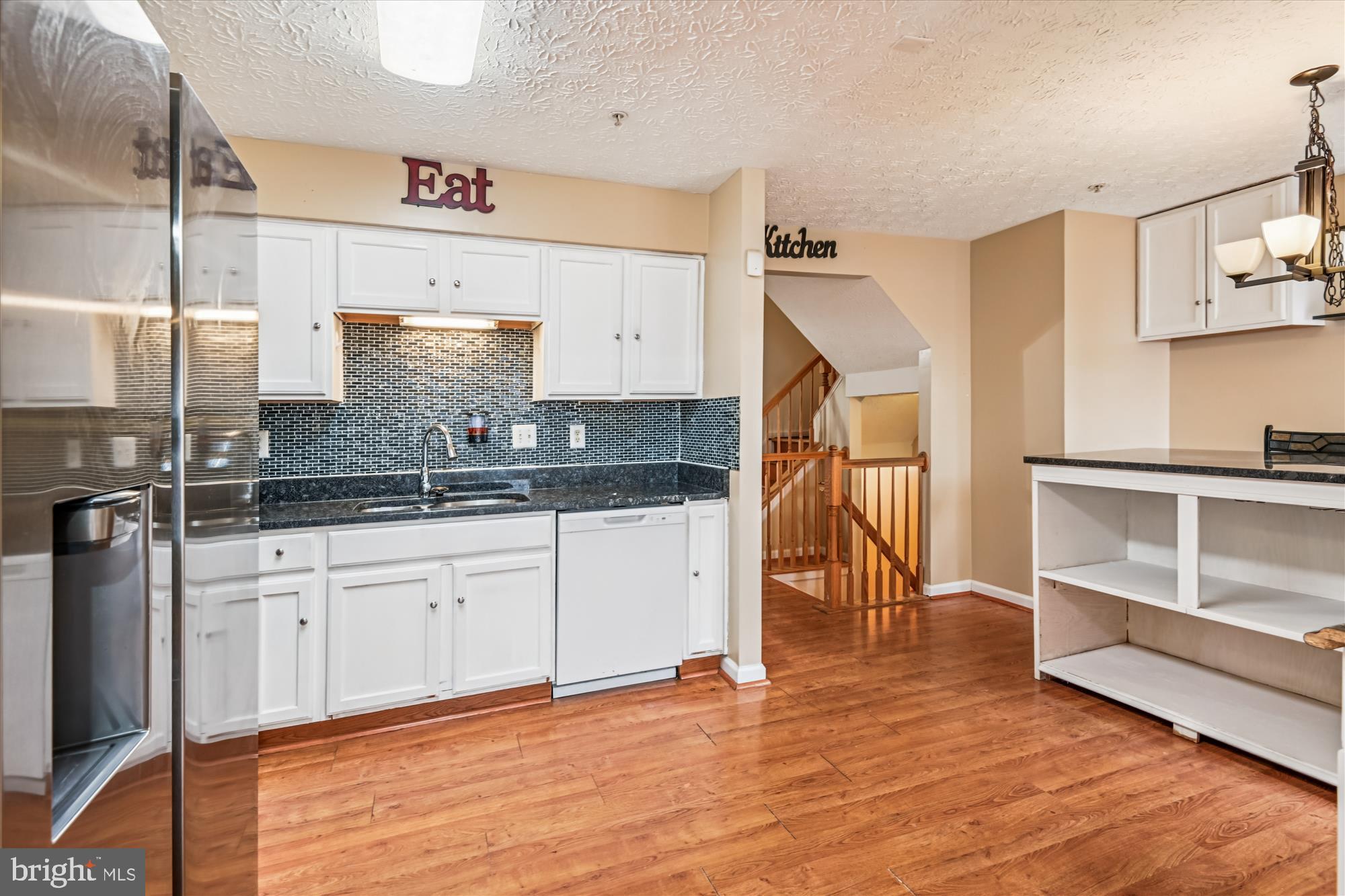 8018 Brookmead Court Severn, MD 21144 - Photo 10 of 35 a kitchen with granite countertop a sink cabinets and stainless steel appliances