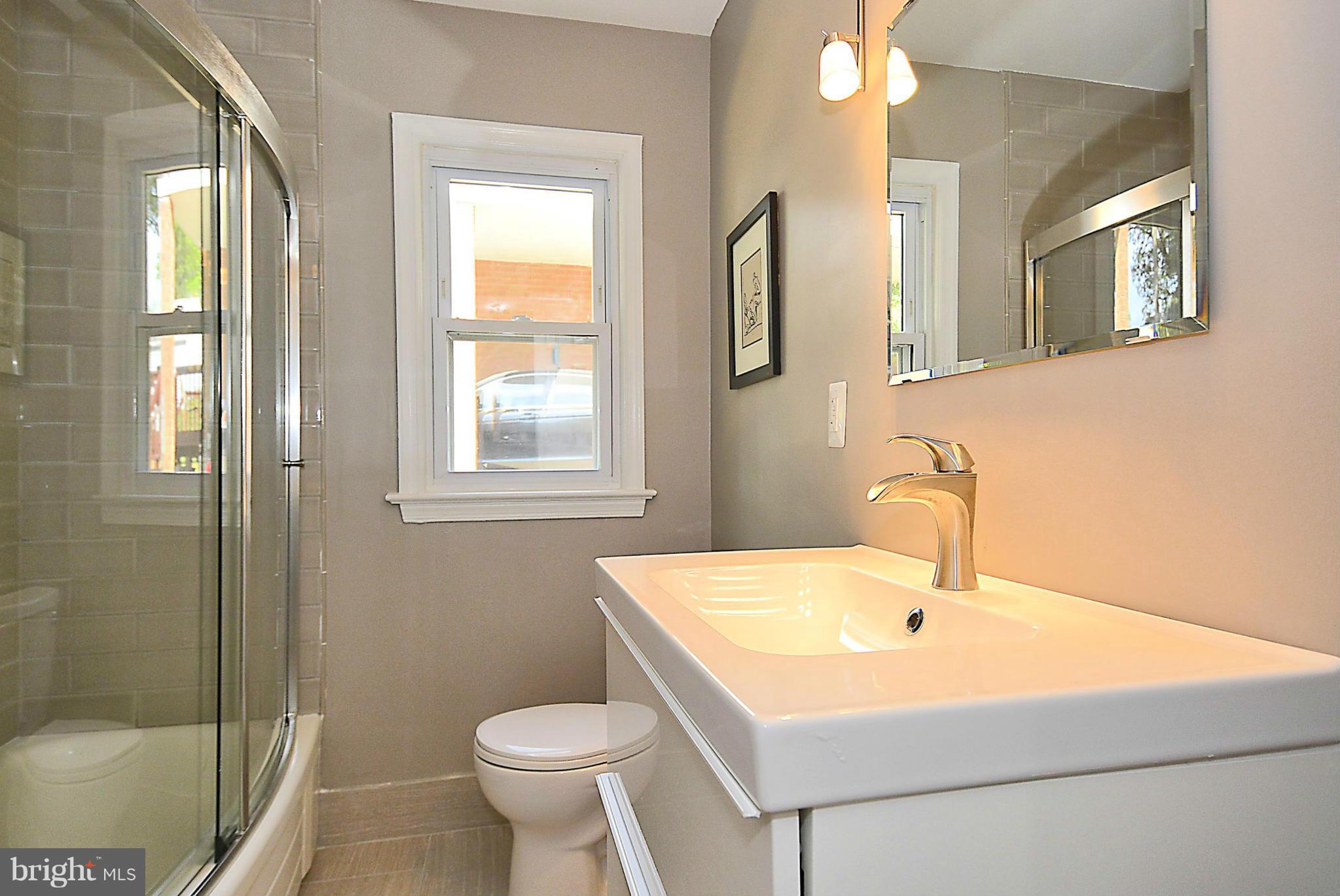 409 Branch Drive Silver Spring, MD 20901 - Photo 15 of 30 a bathroom with a sink toilet and shower