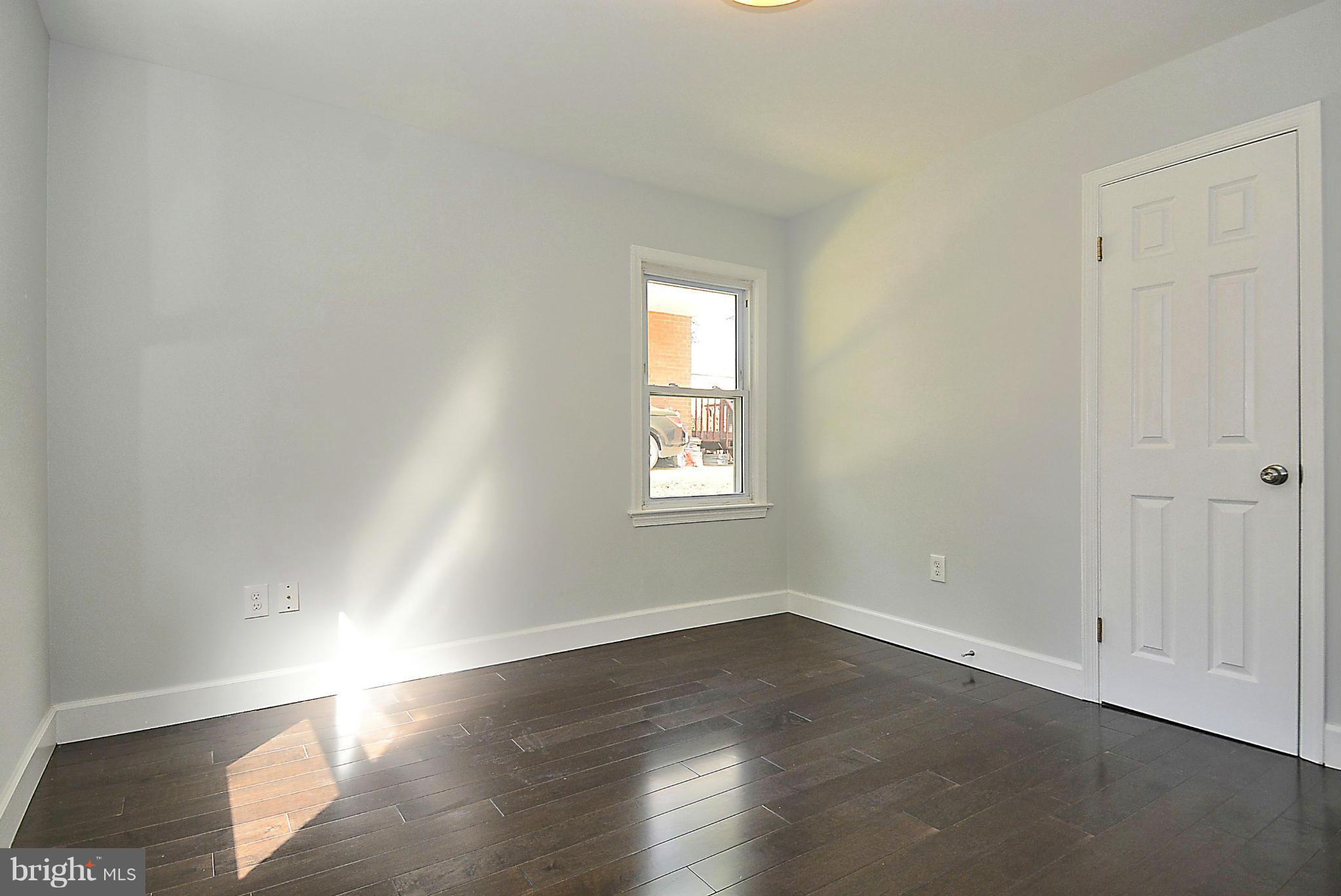 409 Branch Drive Silver Spring, MD 20901 - Photo 16 of 30 an empty room with wooden floor and windows