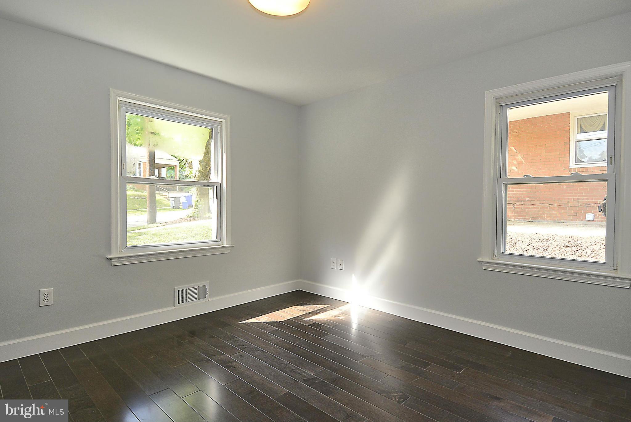 409 Branch Drive Silver Spring, MD 20901 - Photo 17 of 30 a view of an empty room with wooden floor and a window