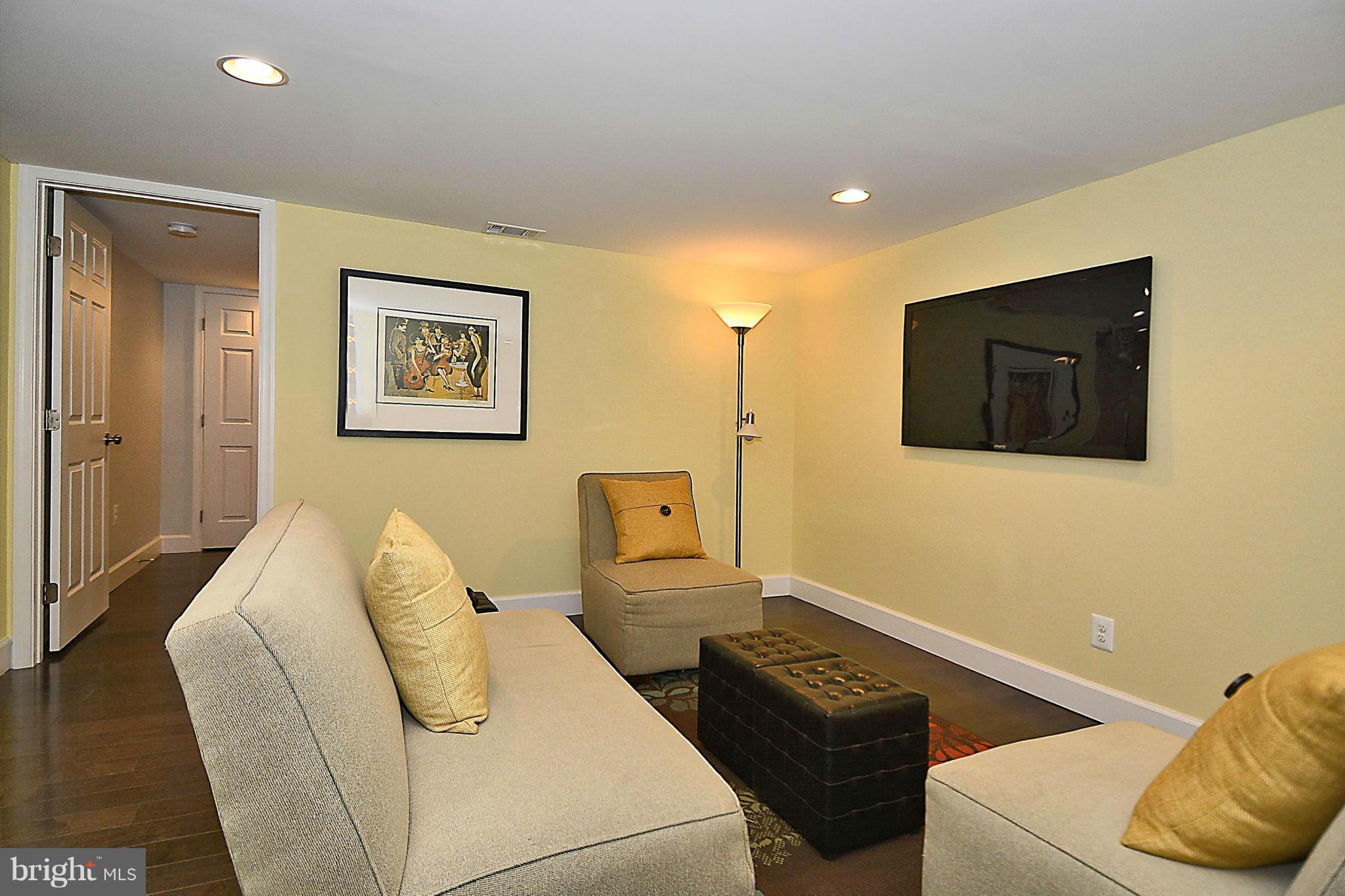 409 Branch Drive Silver Spring, MD 20901 - Photo 20 of 30 a living room with furniture and a flat screen tv