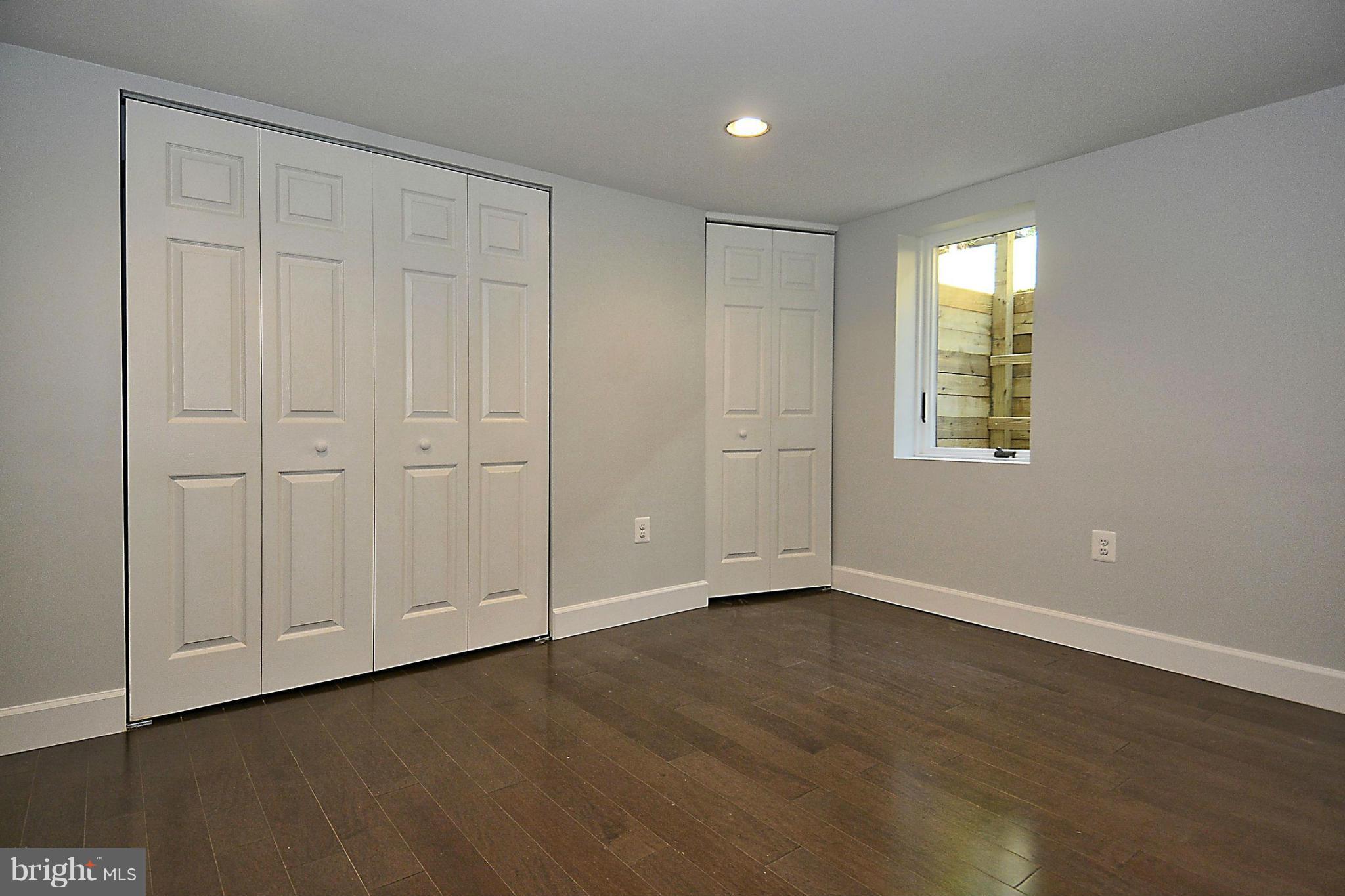 409 Branch Drive Silver Spring, MD 20901 - Photo 24 of 30 an empty room with wooden floor and windows