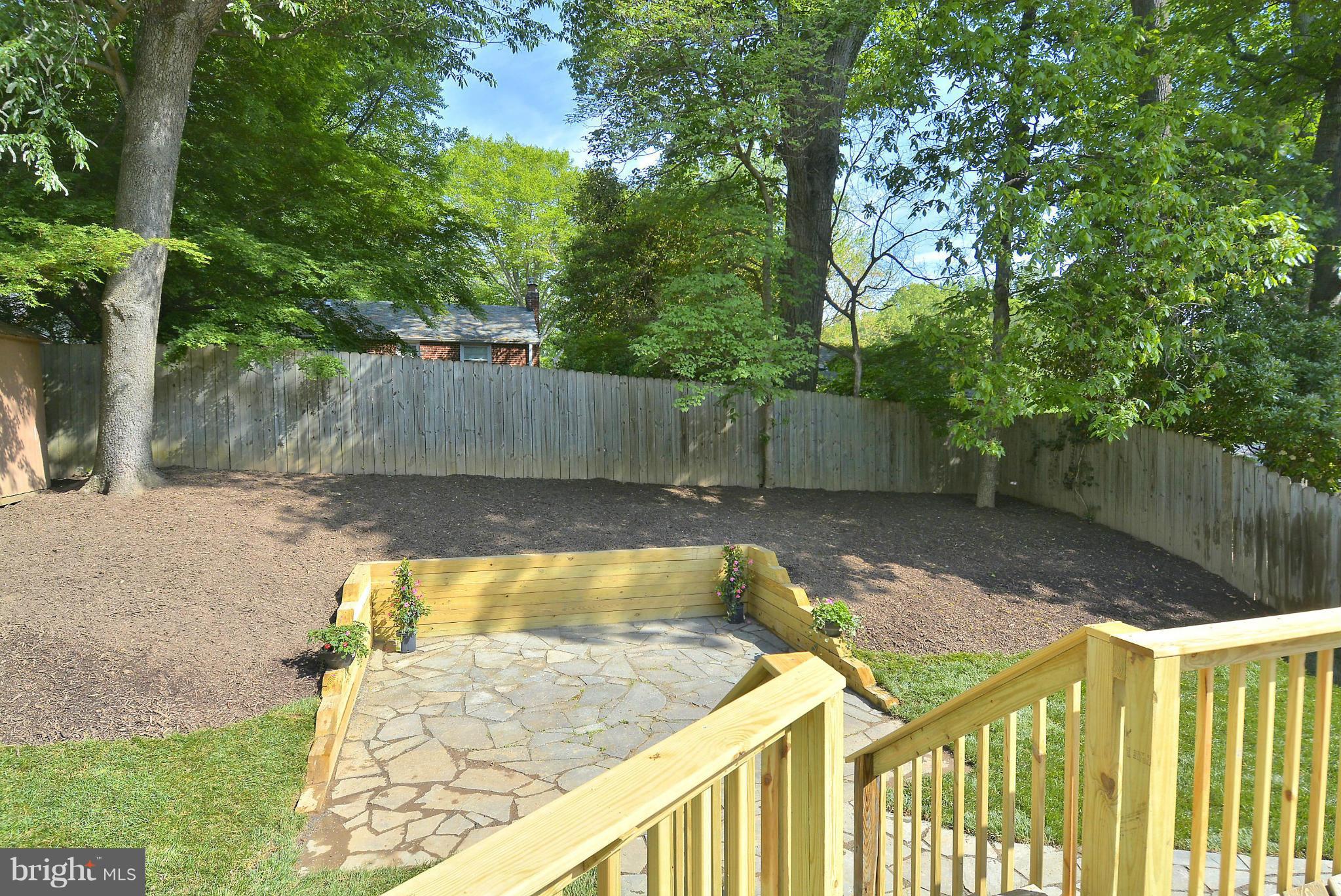 409 Branch Drive Silver Spring, MD 20901 - Photo 26 of 30 a view of a backyard with a tree and wooden fence