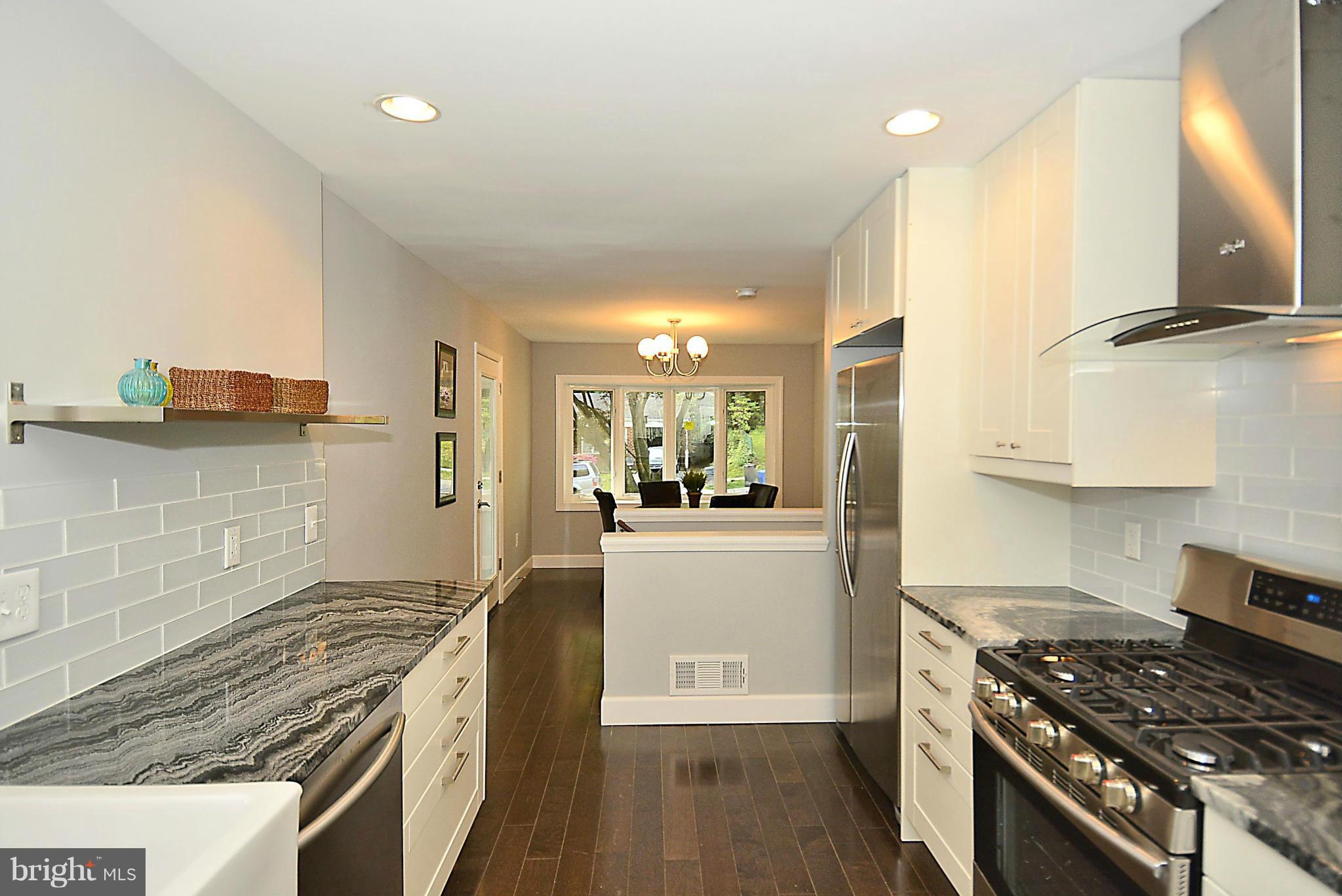 409 Branch Drive Silver Spring, MD 20901 - Photo 8 of 30 a kitchen with stainless steel appliances granite countertop a stove and a refrigerator