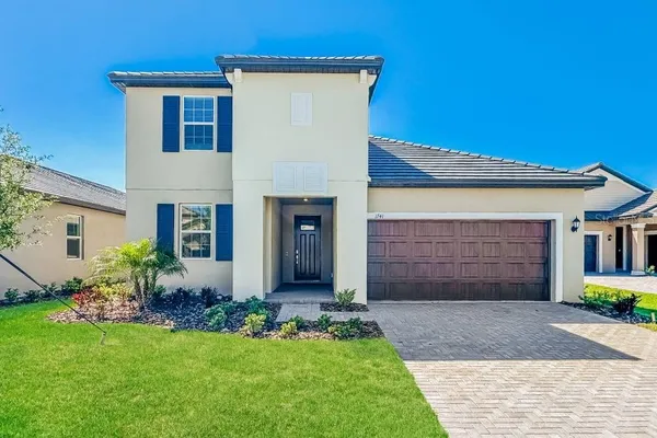 a front view of a house with a yard and garage