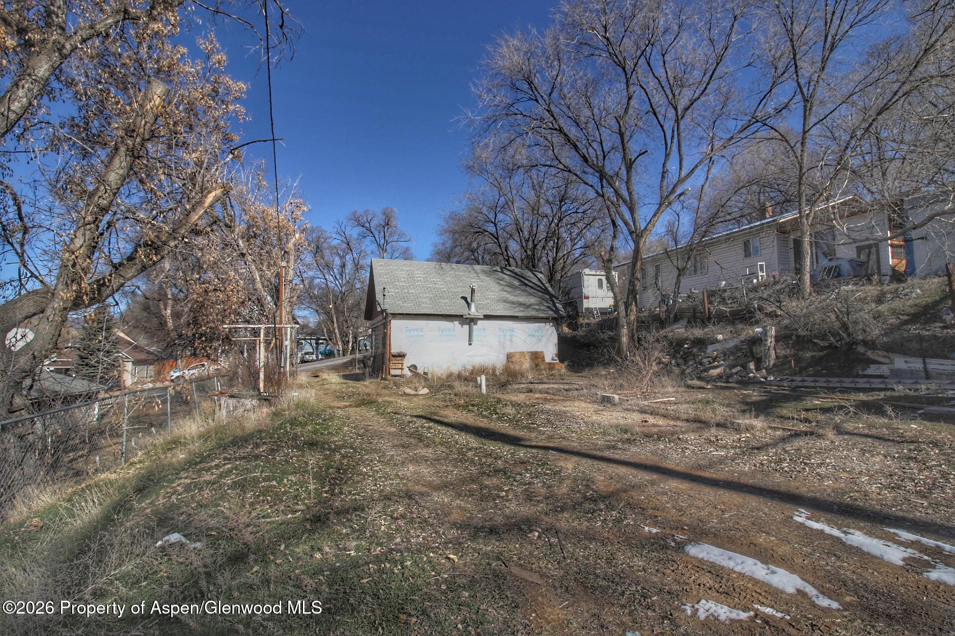 327 East 3rd Street Rifle, CO 81650 - Photo 6 of 6 a view of a dry yard with large trees
