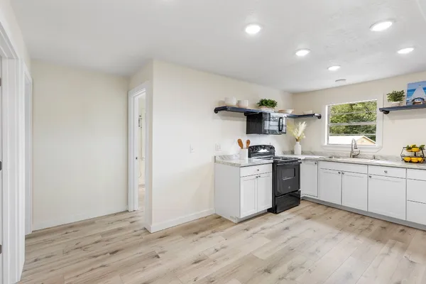 a kitchen with stainless steel appliances a stove a sink and a refrigerator