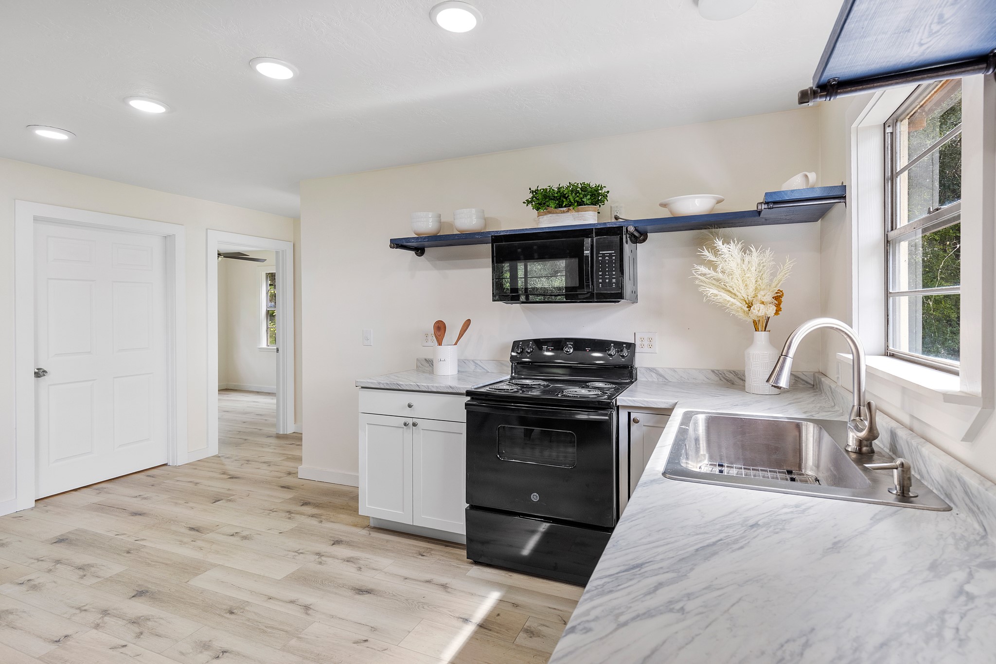 161 White Oak Street Point Blank, TX 77364 - Photo 11 of 23 a kitchen with stainless steel appliances a stove a sink and a refrigerator