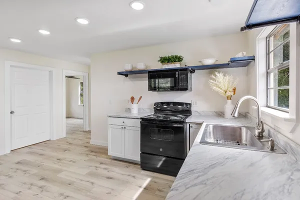 a bathroom with a sink a toilet and a shower