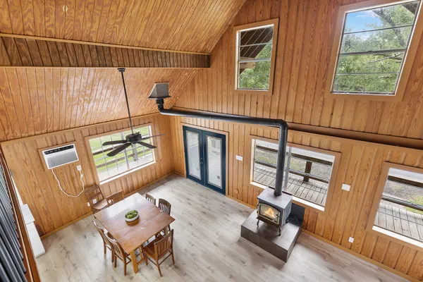 a view of a house with a backyard and a tree