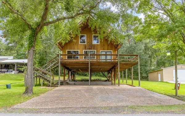 a view of backyard with deck and wooden floor