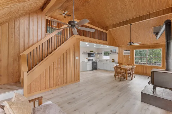 a kitchen with granite countertop a sink cabinets stainless steel appliances and a window
