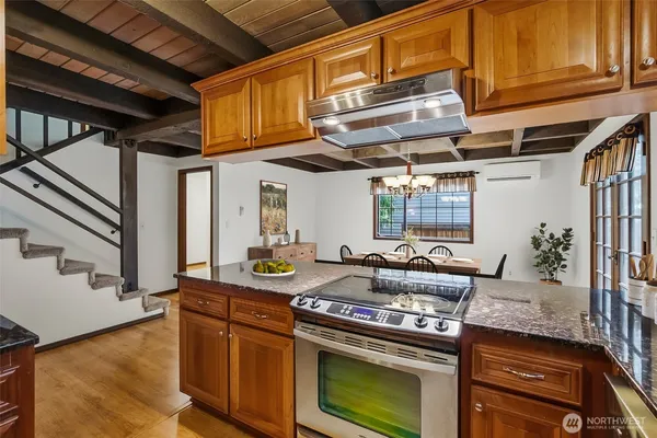 a kitchen with stainless steel appliances granite countertop a stove and a sink