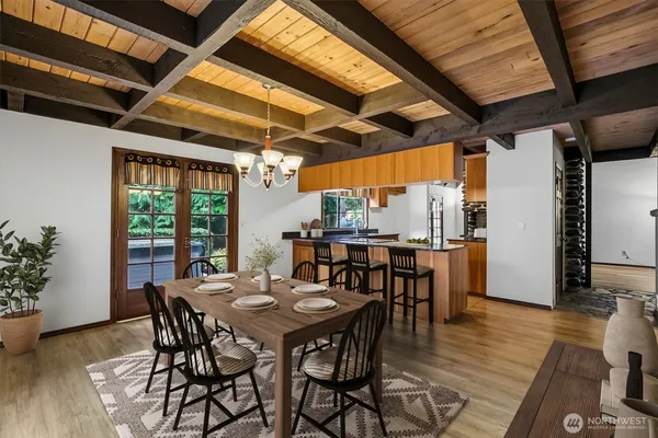 a view of a dining table and chairs in wooden floor