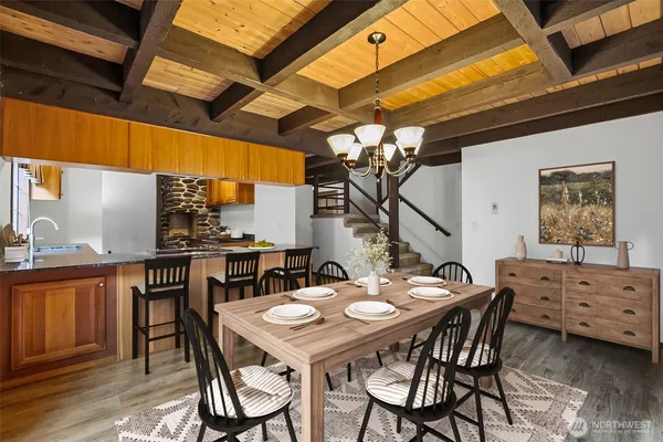 a dining room with a wooden table and chairs