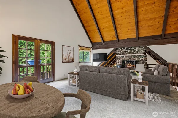a living room with furniture and a floor to ceiling window