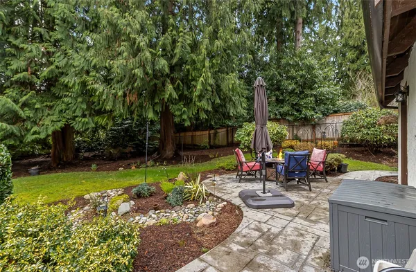 a view of a backyard with sitting area furniture and garden