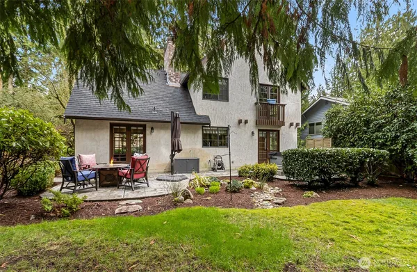 a front view of a house with garden and sitting area